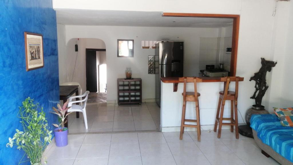 a living room with a couch and a table and a kitchen at Casa de relajación low cost in La Dorada