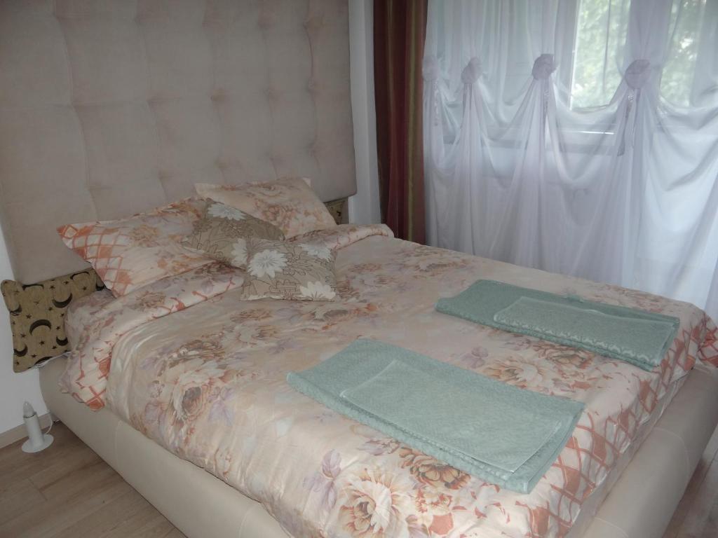 a bed with two towels on top of it at Apartament de lux white&red in Suceava