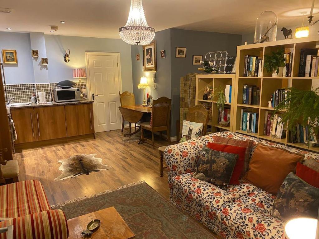 a living room with a couch and a table at Beautifully unique town centre apartment in Macclesfield