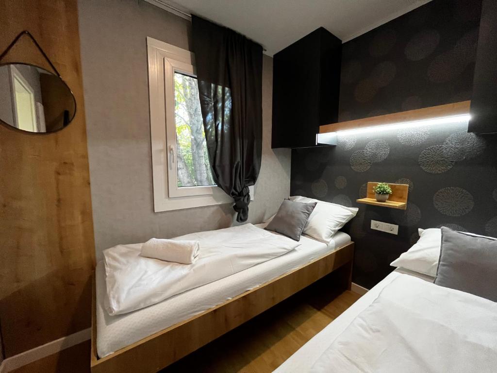 a bedroom with two beds and a window at Premium mobile home Eden in Velenje