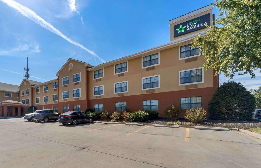 a hotel building with cars parked in a parking lot at Extended Stay America Suites - Oklahoma City - NW Expressway in Oklahoma City