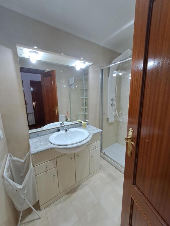 a bathroom with a sink and a shower and a mirror at Casa bella alma in Ramales de la Victoria