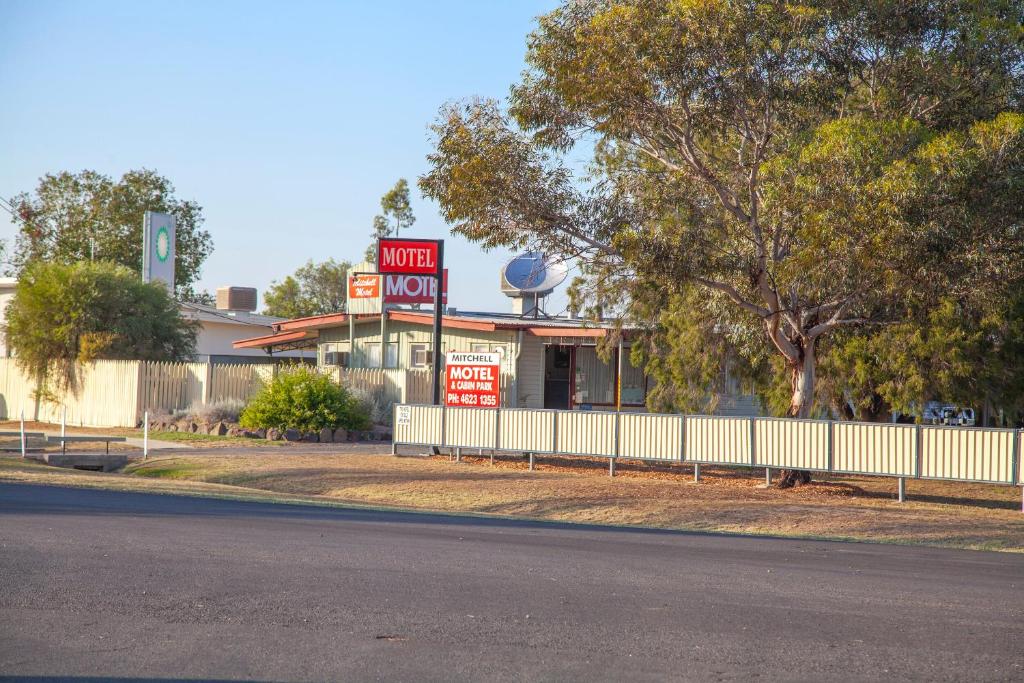 a motel with a sign in front of a building at Mitchell Motel & Cabins in Mitchell