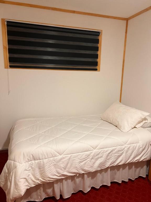 Postel nebo postele na pokoji v ubytování Hostal B&B Coastal Natales