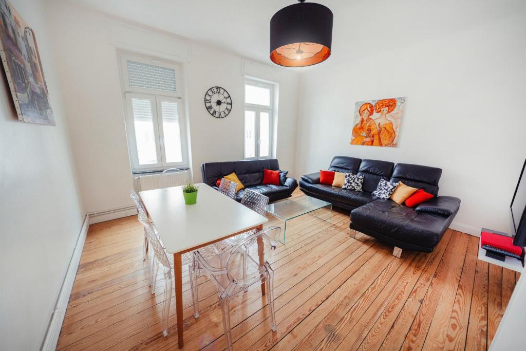 ein Wohnzimmer mit einem Sofa und einem Tisch in der Unterkunft Rock in Share - Le Saint-Pierre in Metz