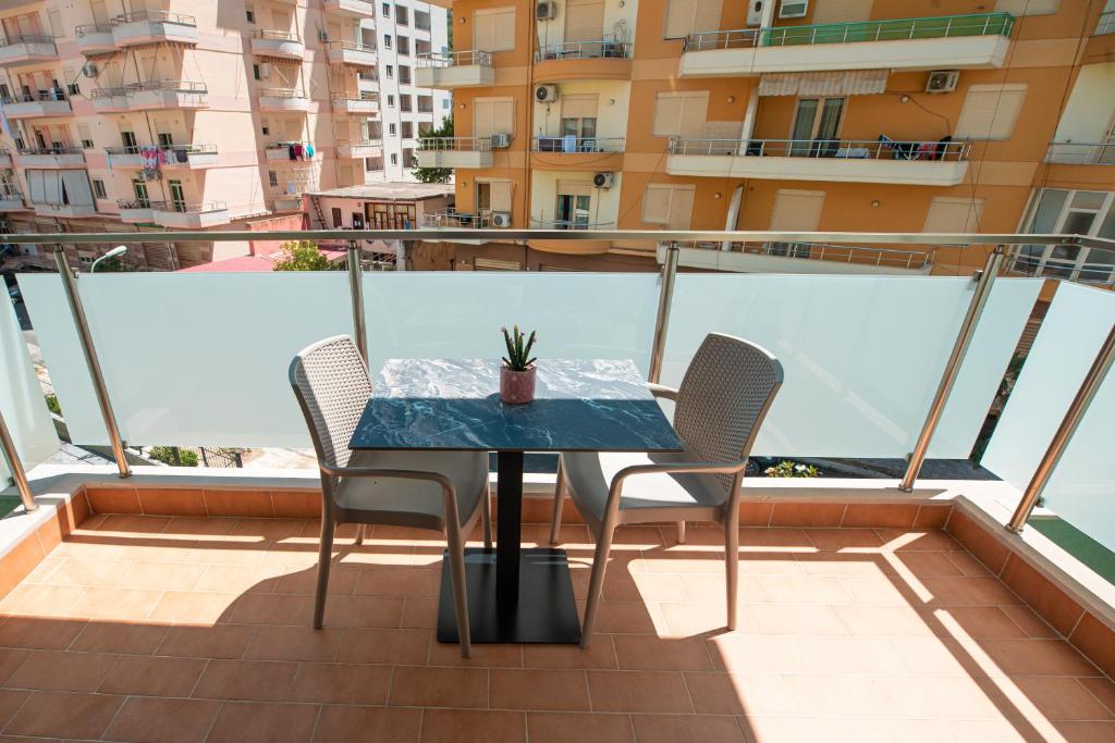 a table and chairs on the balcony of a apartment at Vlore Luxury Apartaments "FAEL" in Vlorë