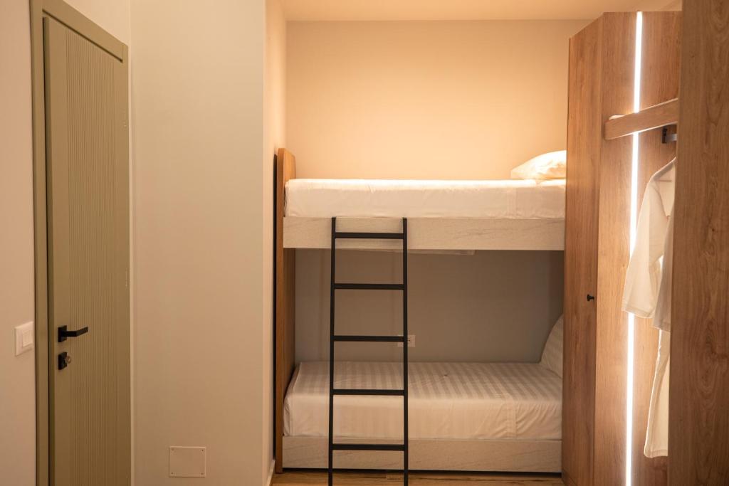 a bunk bed with a ladder in a room at Vlore Luxury Apartaments "FAEL" in Vlorë