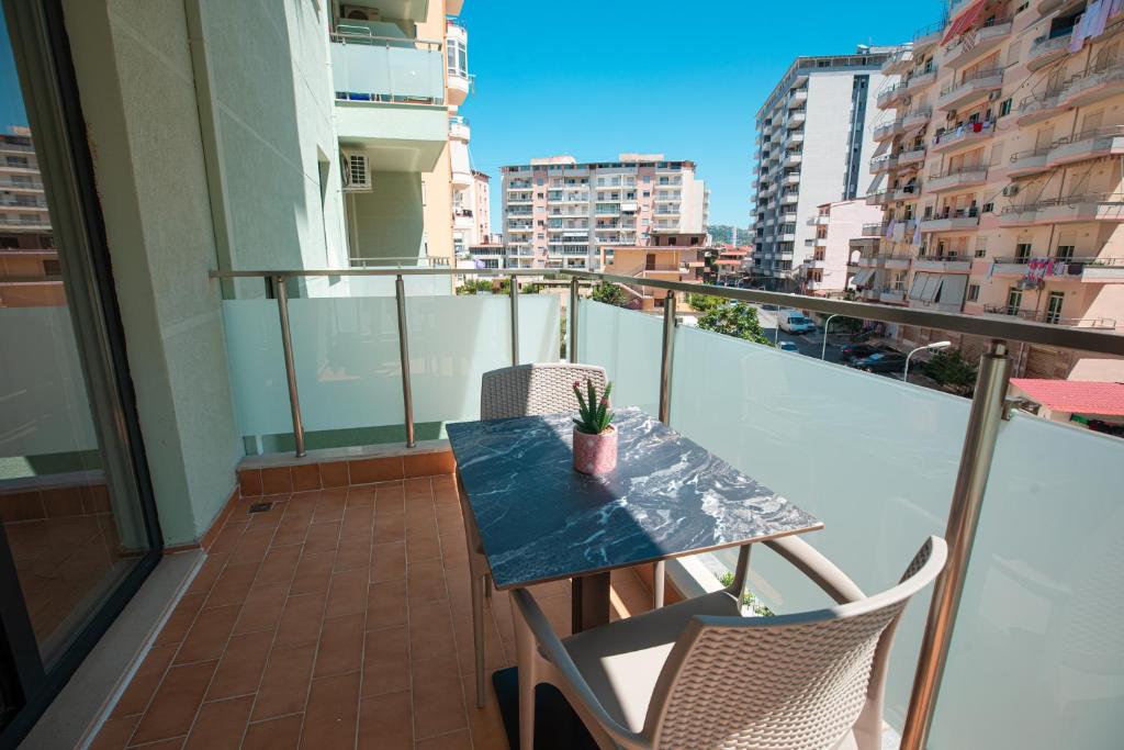 a balcony with a table and chairs on a balcony at Vlore Luxury Apartaments "FAEL" in Vlorë