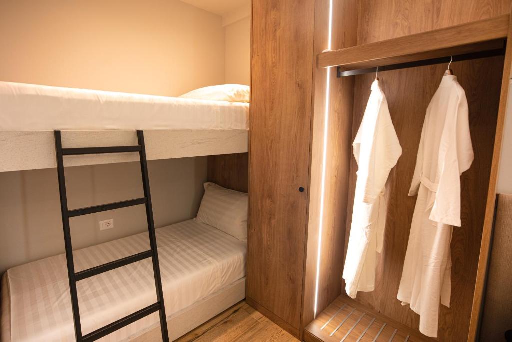 a room with two bunk beds and a closet at Vlore Luxury Apartaments "FAEL" in Vlorë