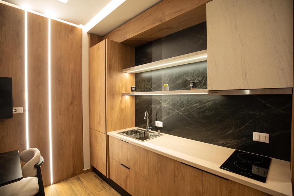 a kitchen with a sink and a counter top at Vlore Luxury Apartaments "FAEL" in Vlorë