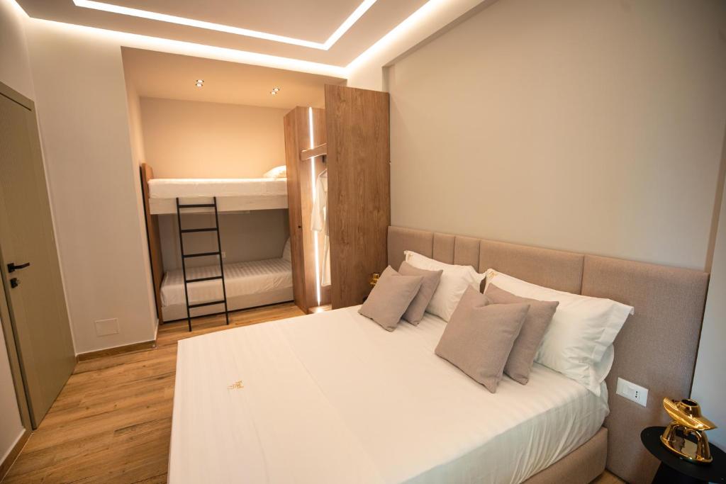 a bedroom with a white bed and a bunk room at Vlore Luxury Apartaments "FAEL" in Vlorë