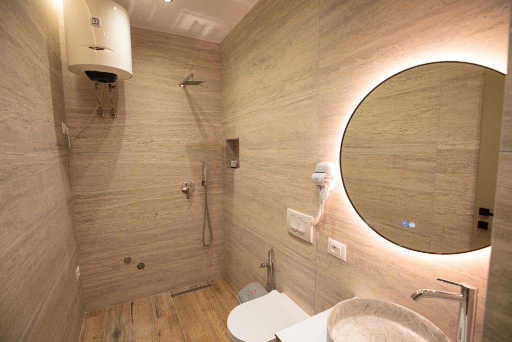 a bathroom with a sink and a mirror at Vlore Luxury Apartaments "FAEL" in Vlorë