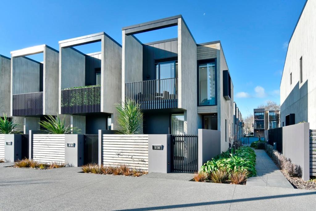 a house with a fence in front of it at Worcester Terrace Eleven - Christchurch Holiday Homes in Christchurch