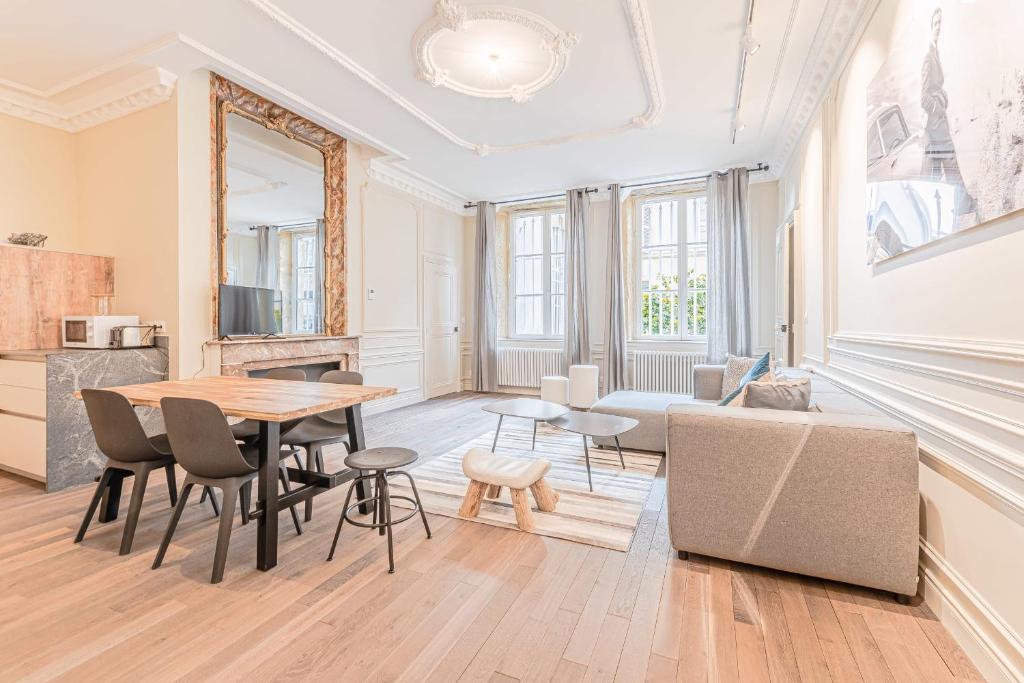 a living room with a table and a couch at La Cour Dorée in Metz