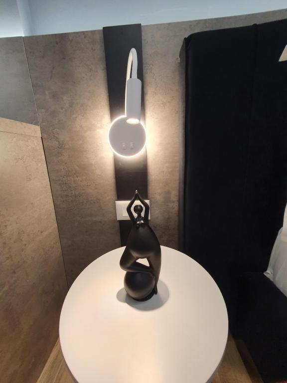 a black object sitting on a white table with a light at Vlore Luxury Apartaments "FAEL" in Vlorë