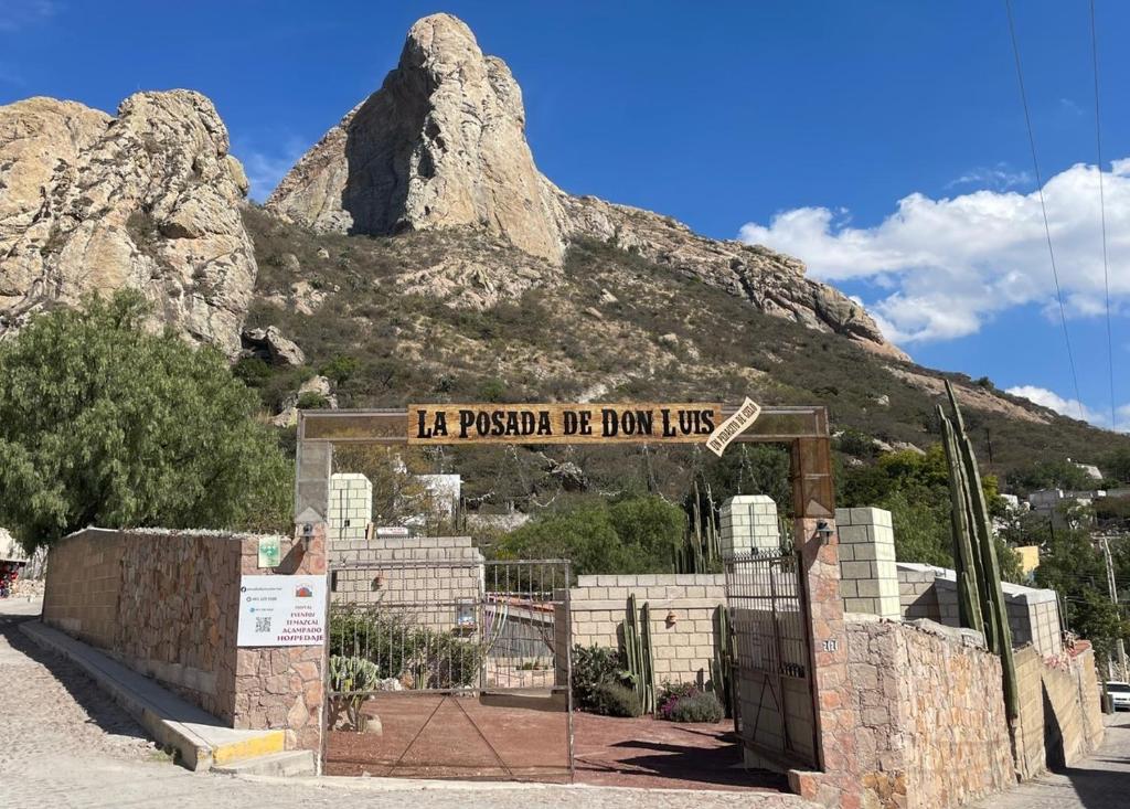 un panneau devant une montagne avec une clôture dans l'établissement Boutique la Posada de Don Luis, à Bernal
