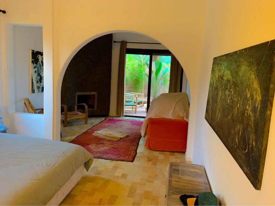 1 dormitorio con 1 cama y 1 habitación con ventana en Bienvenue à la Villa Luxe de 3 Suites pour Location Journée !, en Marrakech