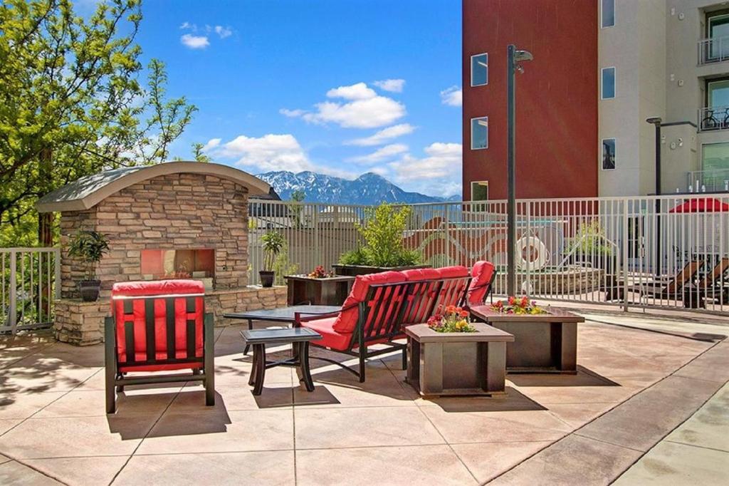 a patio with two chairs and a brick fireplace at Luxury Condo in the Best Part of Downtown in Salt Lake City