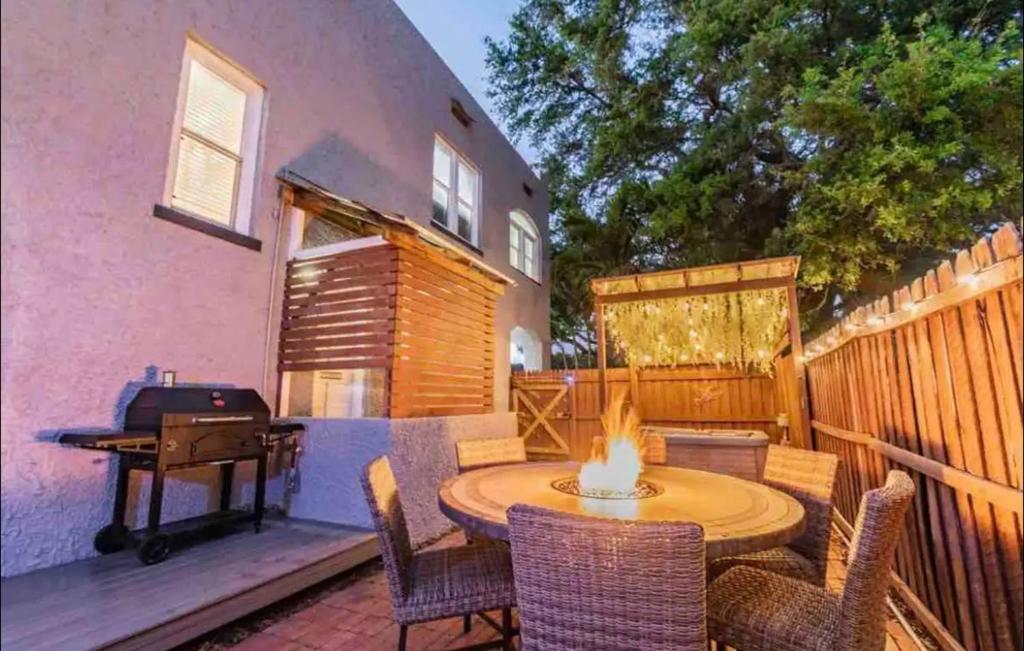 a patio with a table and chairs and a grill at Lake apt 5 minutes to downtown in St Petersburg