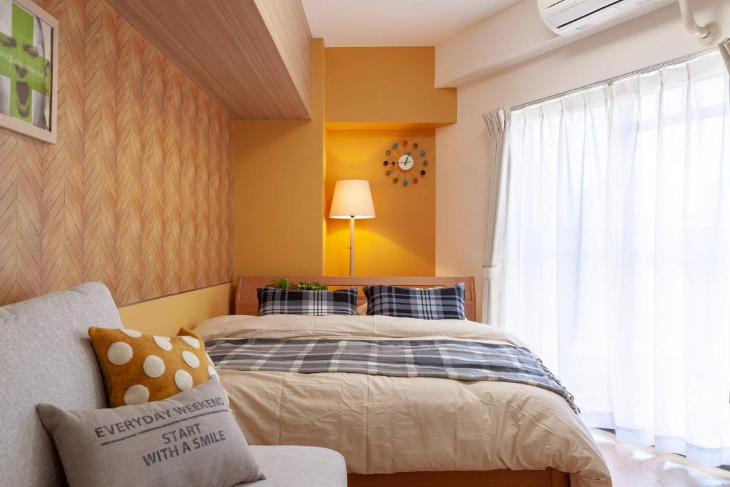 a bedroom with two beds and a window at Saison Daikanyama - Ebisu Nishi in Tokyo