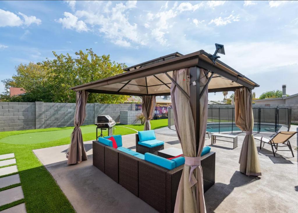 a backyard with a gazebo and a pool at Resort-style home with pool in Phoenix minutes from State Farm Stadium! in Phoenix