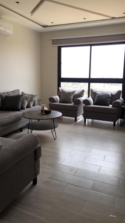 a living room with couches and a table at شقة خاصه مطله على الجبل in Al Baha