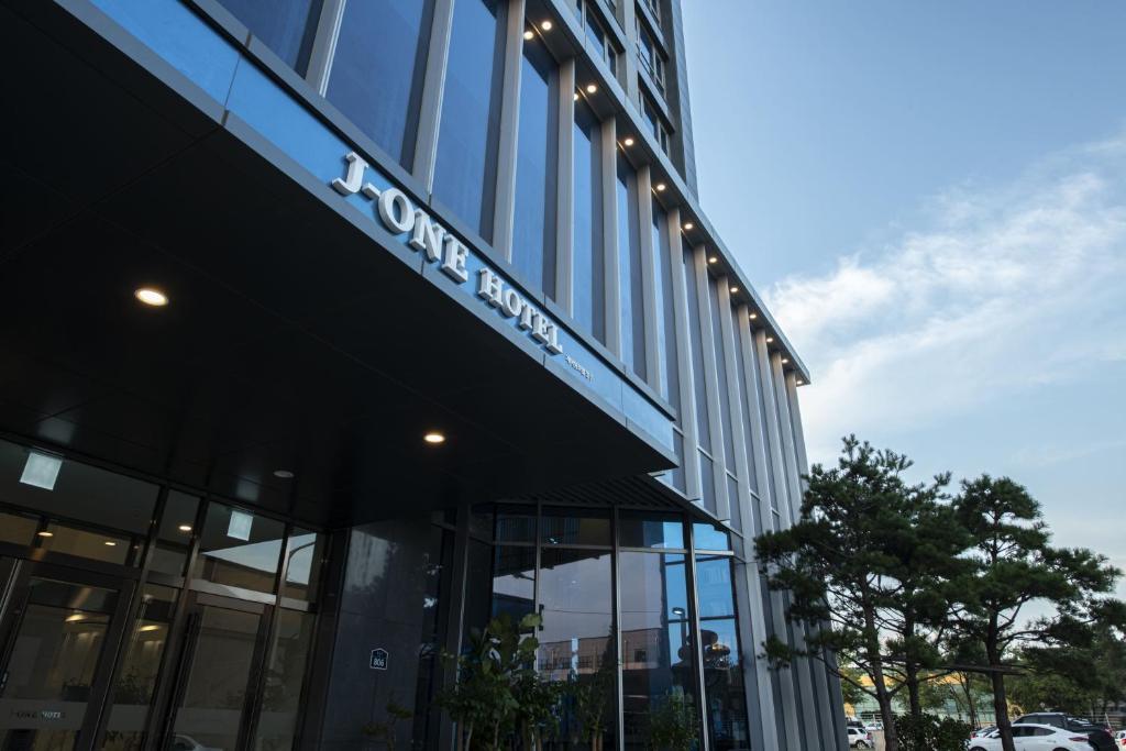 a building with a sign on the side of it at J One Hotel Cheongju in Cheongju