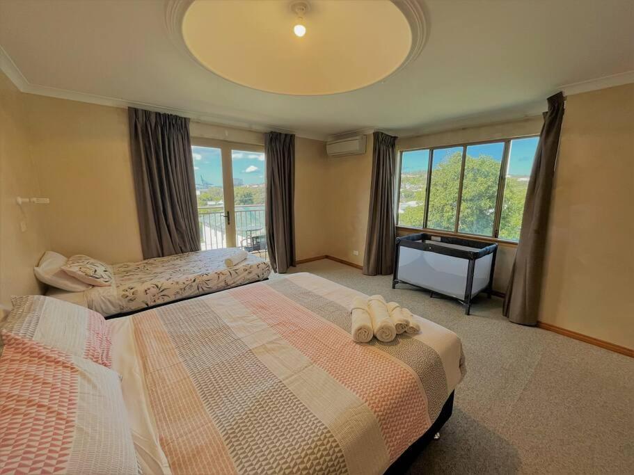 a bedroom with two beds and a large window at Emily St Escape in Esperance