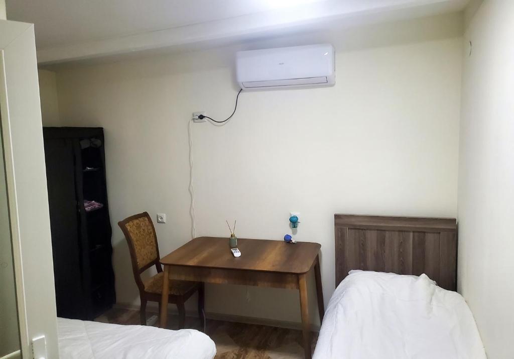 a room with a table and a bed and a desk at Green Palma in Kutaisi