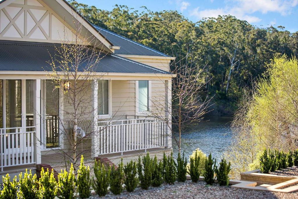 a house with a river in front of it at Lakes Edge in Daylesford