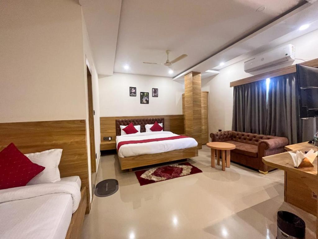 a hotel room with a bed and a couch at AIR VALLEY INN in Guwahati