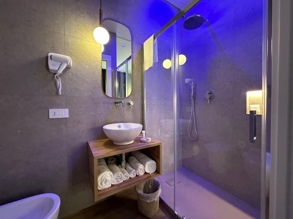 a bathroom with a sink and a shower at Krysos Luxury Rooms in Agrigento