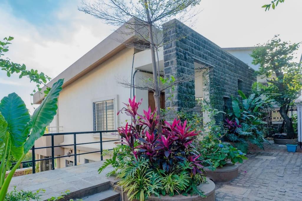 a house with a bunch of plants in front of it at Par-X Mist View 9A Garden Villa 3BHK in Lonavala