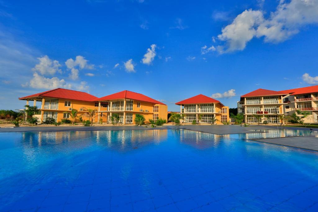a view of a resort with a large swimming pool at Passi Villa in Pasikuda