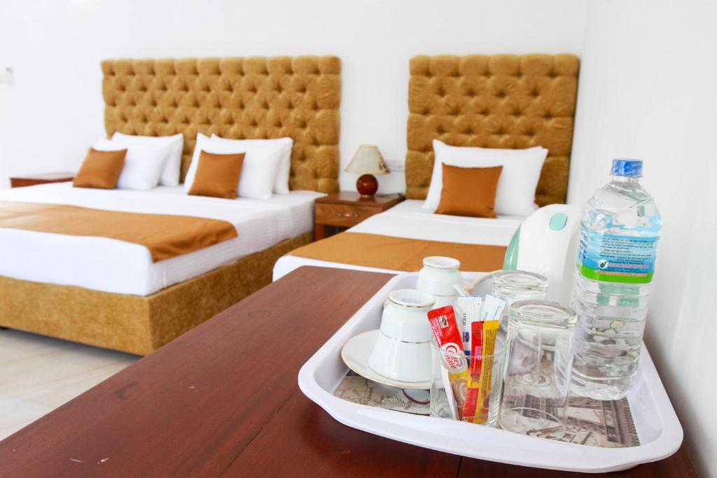 Postel nebo postele na pokoji v ubytování Hotel Nilketha Yala Tissamaharama