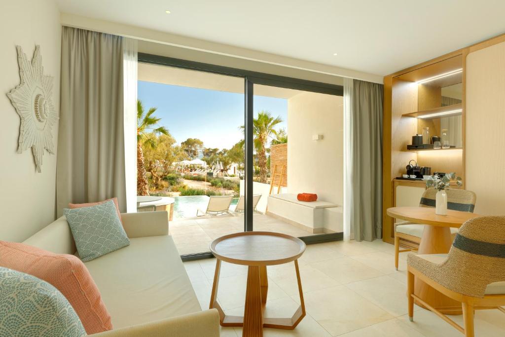 a living room with a couch and a table at The Signature Level at TRS Ibiza Hotel - All Inclusive Adults Only - Entrance to Clubs included in San Antonio