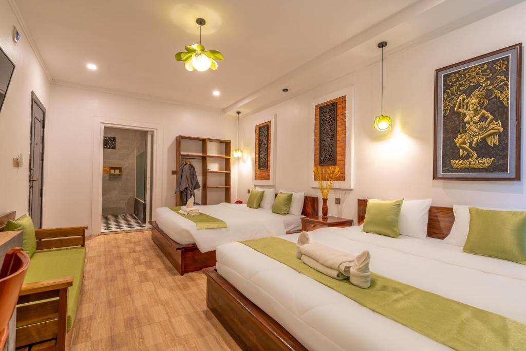 Postel nebo postele na pokoji v ubytování Angkor Rithy Boutiquese