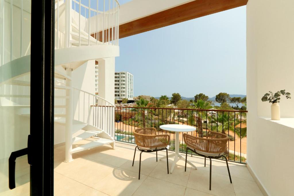a balcony with a table and chairs at The Signature Level at TRS Ibiza Hotel - All Inclusive Adults Only - Entrance to Clubs included in San Antonio