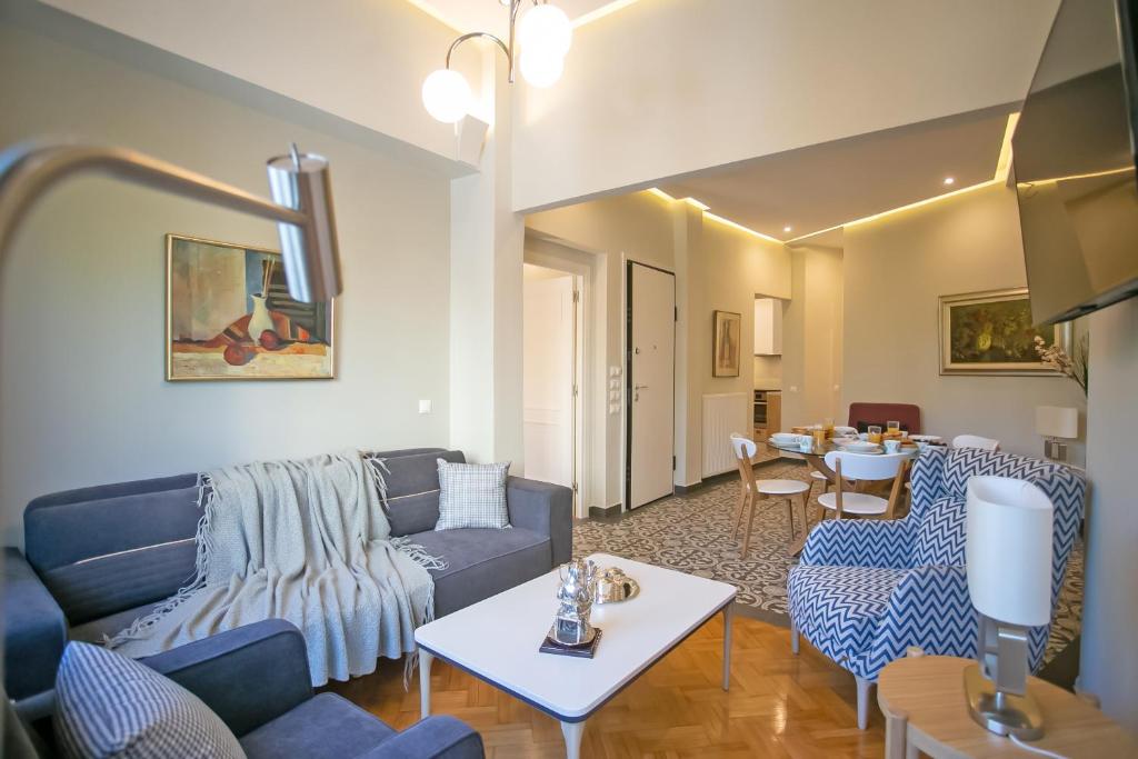una sala de estar con un sofá y una mesa en Thalia by Heloni Apartments, en Atenas