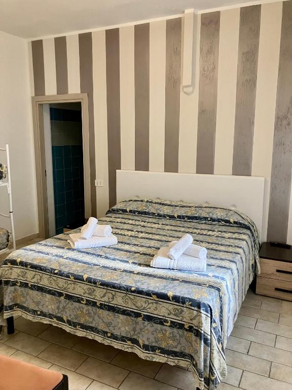 Postel nebo postele na pokoji v ubytování Hotel Ginevra e Residence