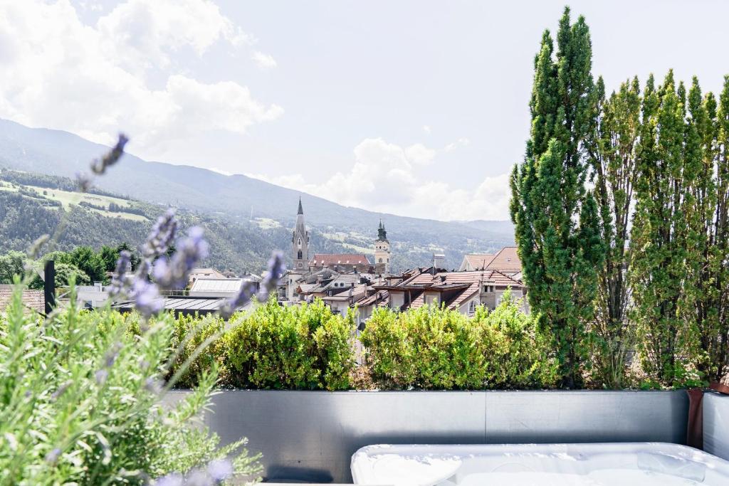 a view of a city from a garden at Soley Suites - adults only in Bressanone