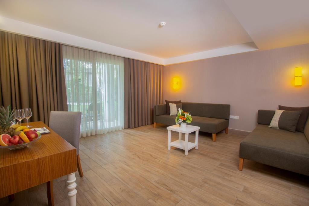 a living room with two couches and a table at Sherwood Exclusive Kemer - Kids Concept in Kemer