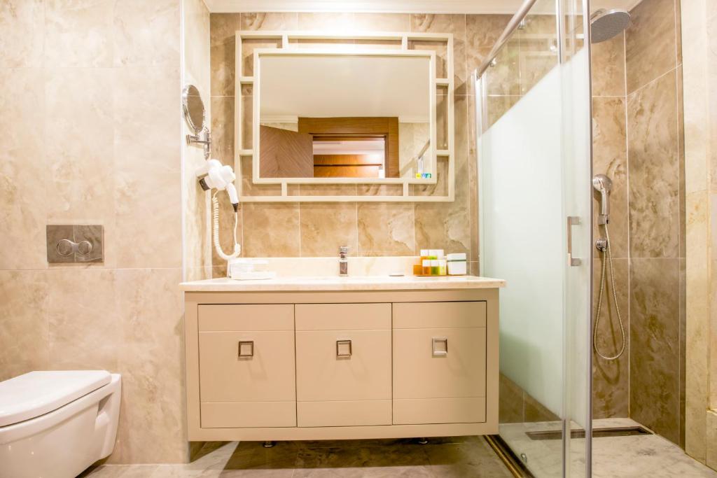 a bathroom with a sink and a shower at Sherwood Exclusive Kemer - Kids Concept in Kemer
