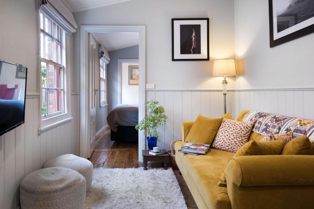 a living room with a couch and a table at Persimmon in Clunes