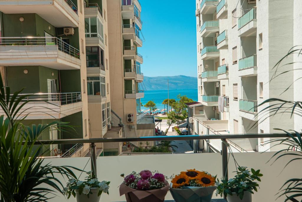 a view from a balcony in a building with flowers at Vlore Luxury Apartaments "FAEL" in Vlorë