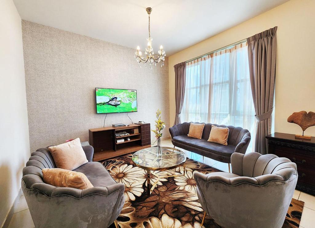 uma sala de estar com duas cadeiras e um sofá em RH- The Perfect Family Getaway, 3BR in Standpoint Tower em Dubai