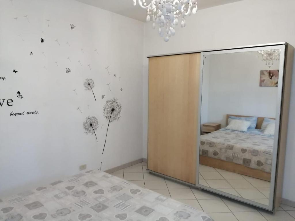 a bedroom with a mirror and a bed and a bed sidx sidx sidx at Casa di mezzo in Rio Marina