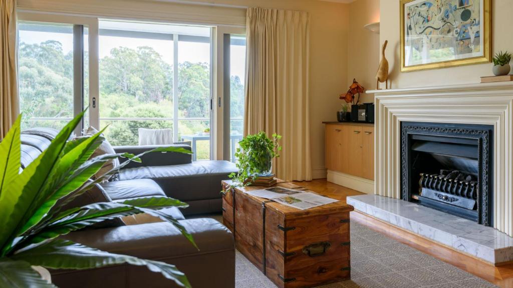 a living room with a couch and a fireplace at Lakeside Suite 3 - Lake View & Spa Bath in Daylesford
