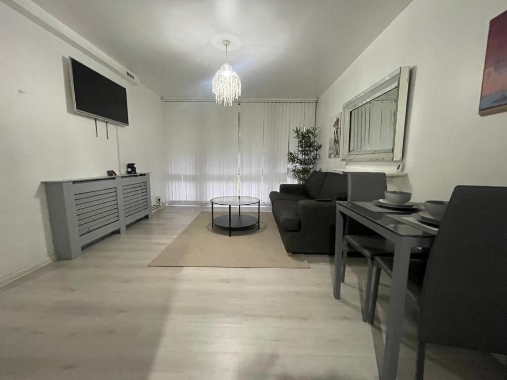 a living room with a couch and a table at NEW! Xtra Large 4 bedroom Up to 12 guests in Woolwich
