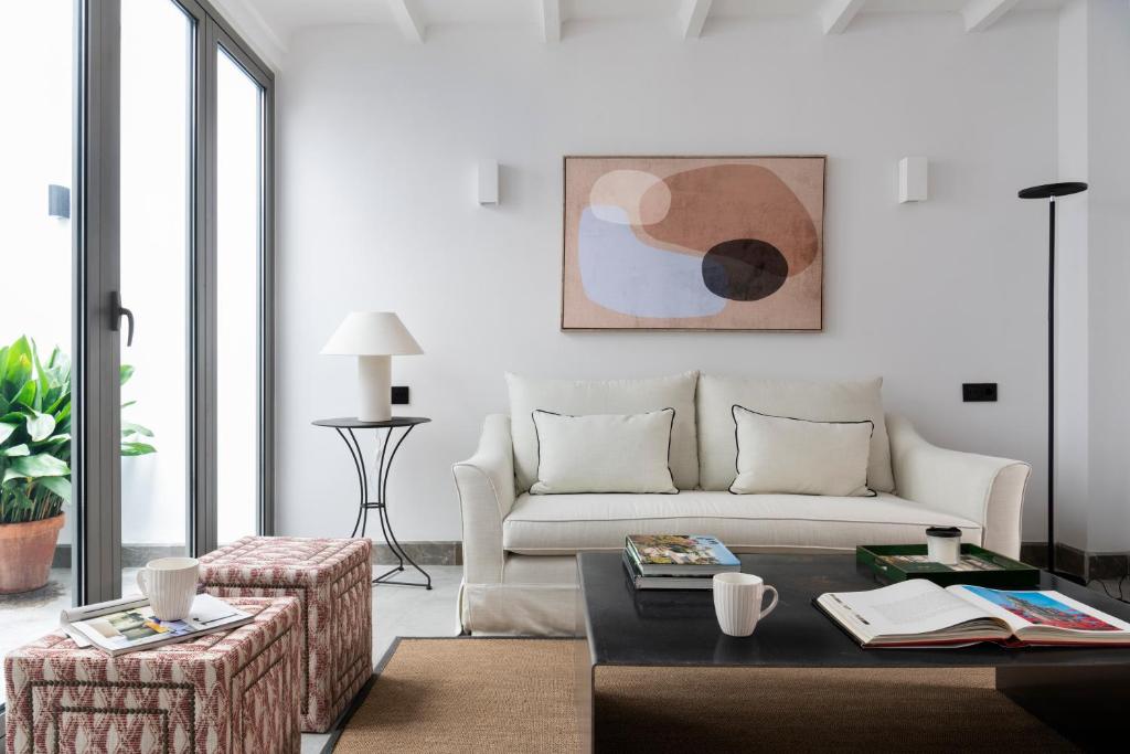 uma sala de estar com um sofá e uma mesa em Magno Apartments Fabiola 7 Luxury House em Sevilha